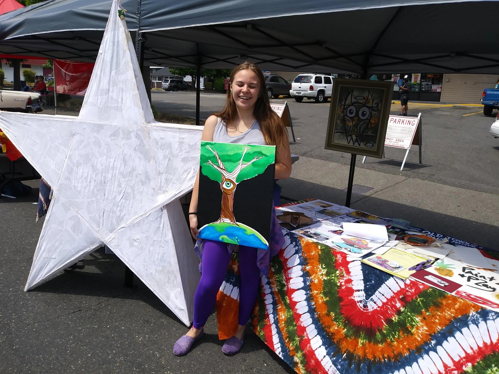 MaKenzie at THE WALL install — Art on the Ave, 2017 — with the Star of Destiny and her painting.